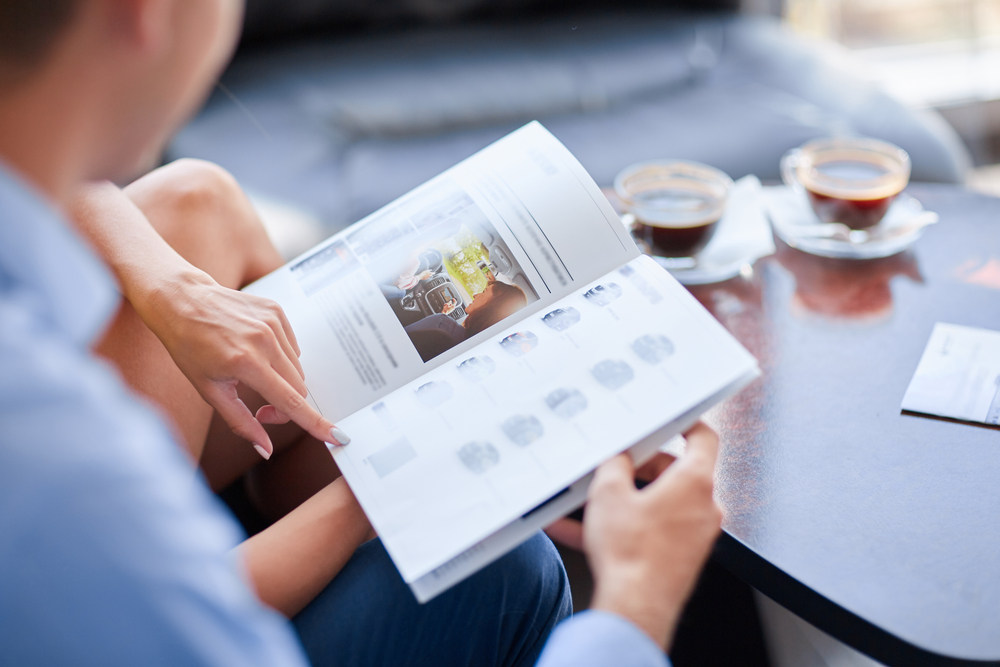 Couple reading booklet (Now is the Time to Print Catalog and Booklets)