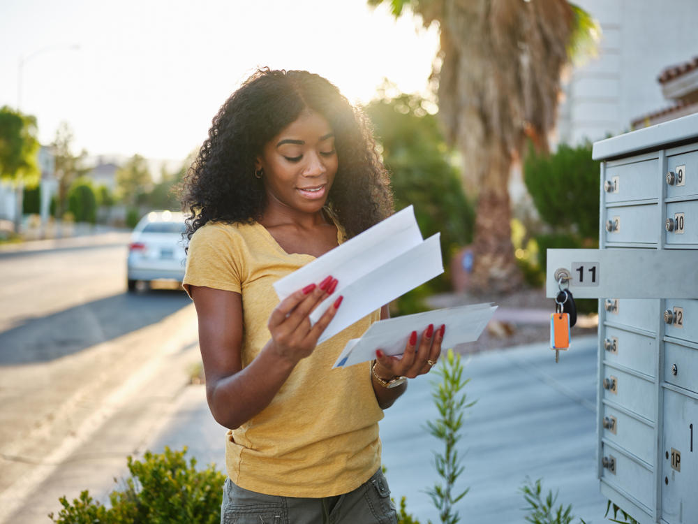 Woman and daughter looking at mail - Top Benefits of Direct Mail Marketing